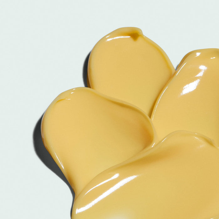 Close-up of smooth yellow cream texture swatched on a light surface representing ORMESIC balancing biopeptide crème | IMAGE Skincare for skincare and body care use.