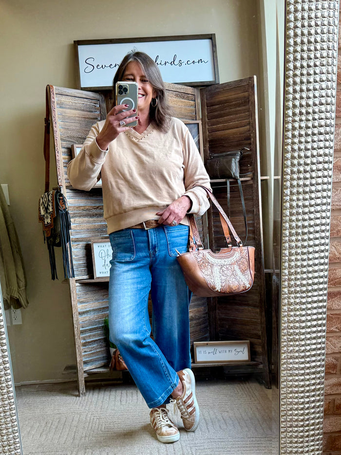 Blue cropped jeans with patch pockets, belt loops, and button fly
