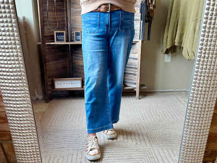 Blue cropped jeans with patch pockets and cuffed hem