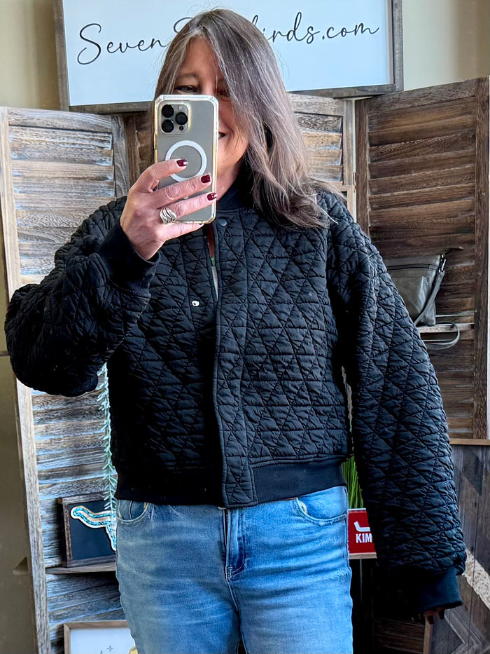 Quilted snap-front bomber jacket in dark black with diamond stitching and stand collar