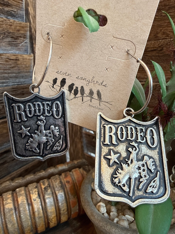 Rodeo shield earrings with star and cowboy figures, silver hoop dangle