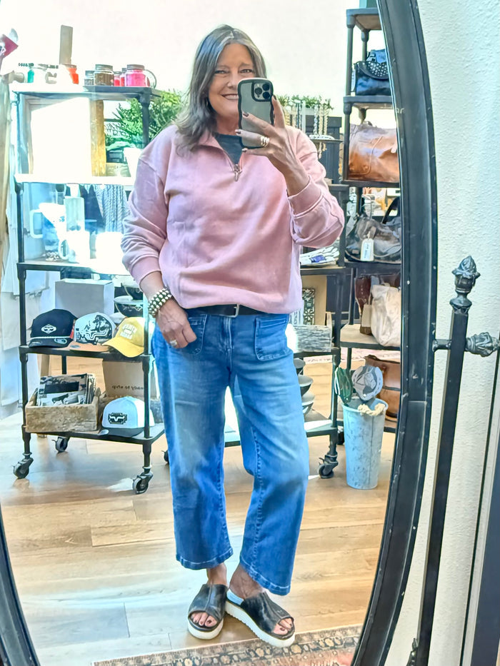 Light pink quarter-zip pullover sweatshirt with standing zipper placket and ribbed cuffs