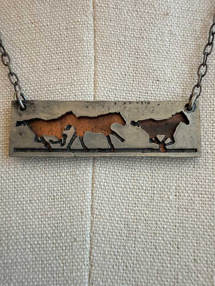 Pewter and copper running horses bar pendant on a silver-tone chain