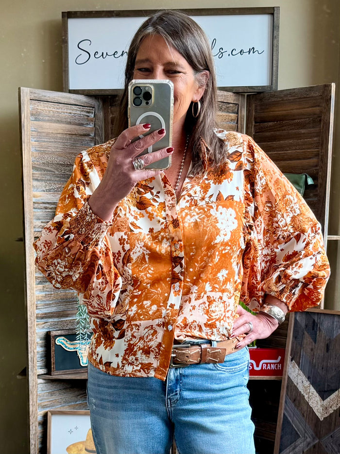 Rust floral balloon-sleeve blouse with V-neck and button front, rust and cream