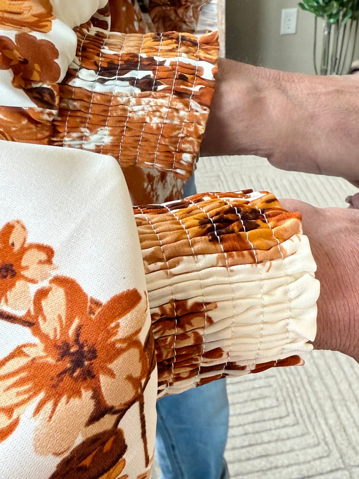 Rust floral blouse with puff sleeves and ruched shoulder detail, gathered front