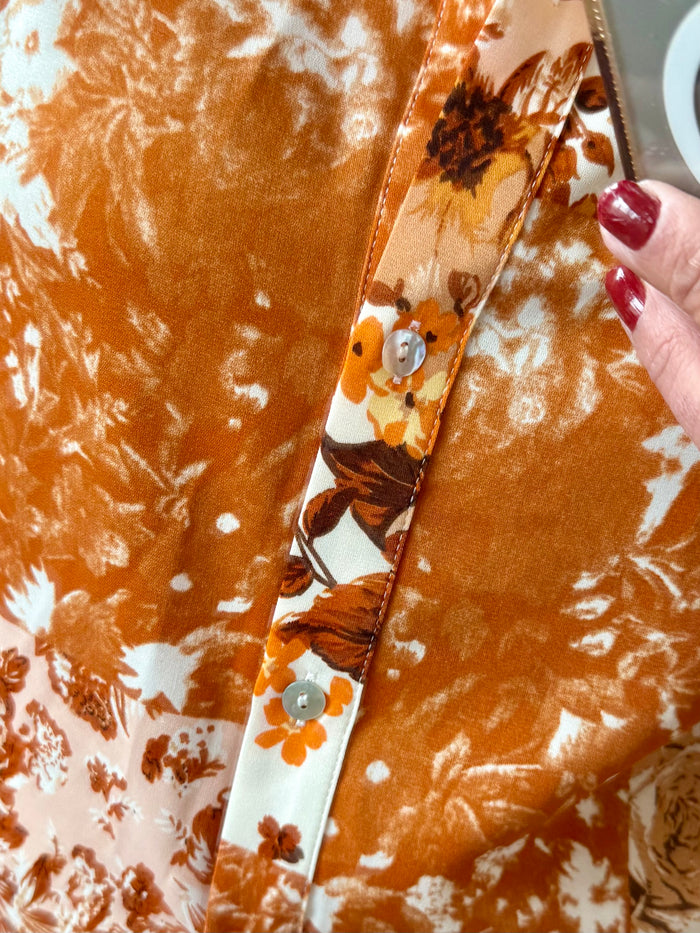 Rust floral blouse close-up of button placket and patterned sleeve cuff