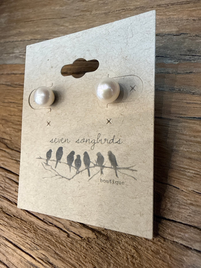 Round freshwater pearl stud earrings with sterling silver posts, displayed on a card