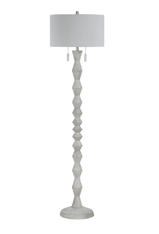 White floor lamp with a white shade on a white background