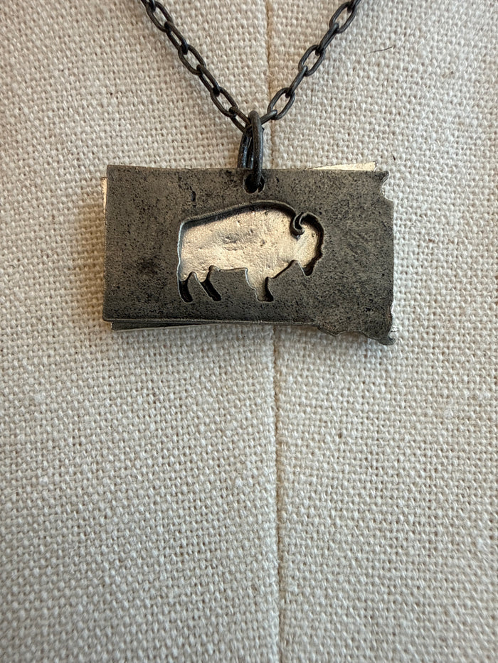 Rectangular pewter pendant with buffalo silhouettes on dark chain