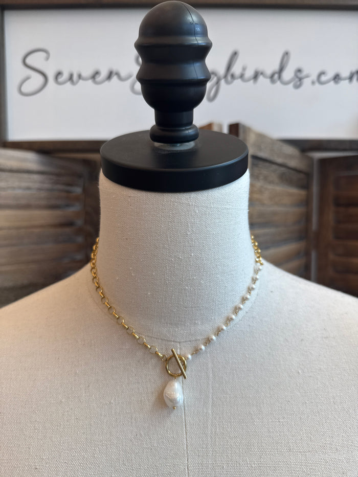 Gold toggle clasp necklace with small white pearl drop and delicate gold chain