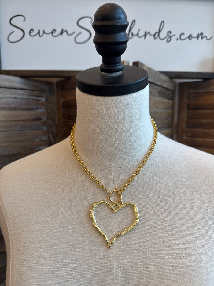 Gold-tone heart pendant toggle clasp necklace on mannequin