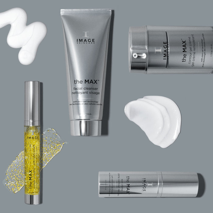 Assorted skincare products from IMAGE Skincare including the MAX™ facial cleanser and the MAX™ eye crème | IMAGE Skincare with cream and serum textures displayed on a gray background.