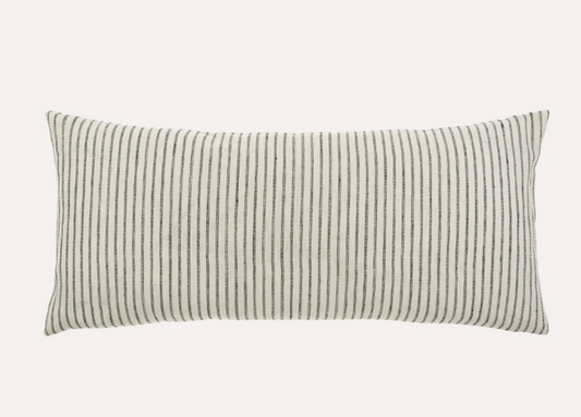 A rectangular linen pillow with a classic ticking stripe pattern in beige and black.
