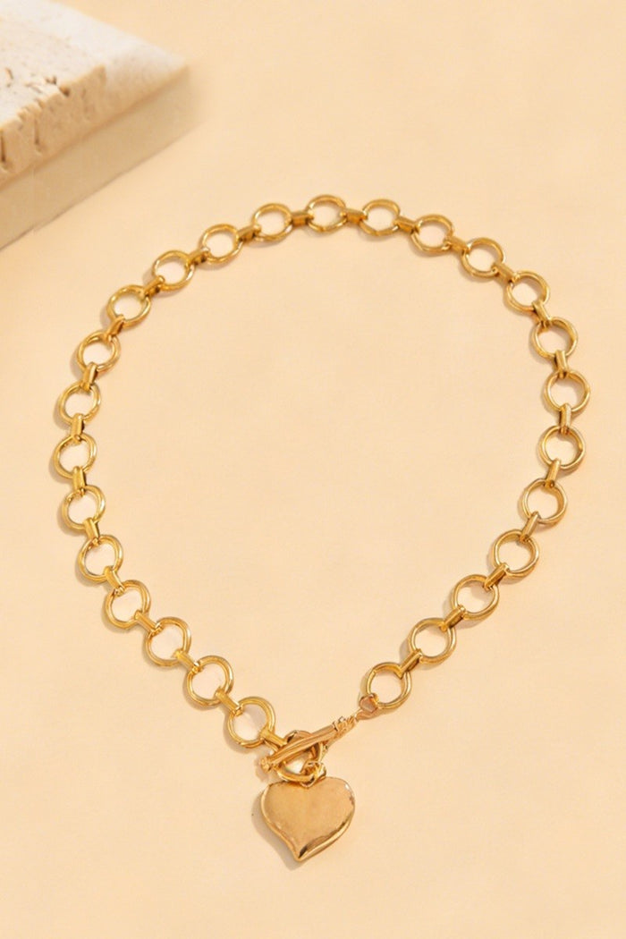 Gold heart toggle necklace with oval link chain and heart charm pendant