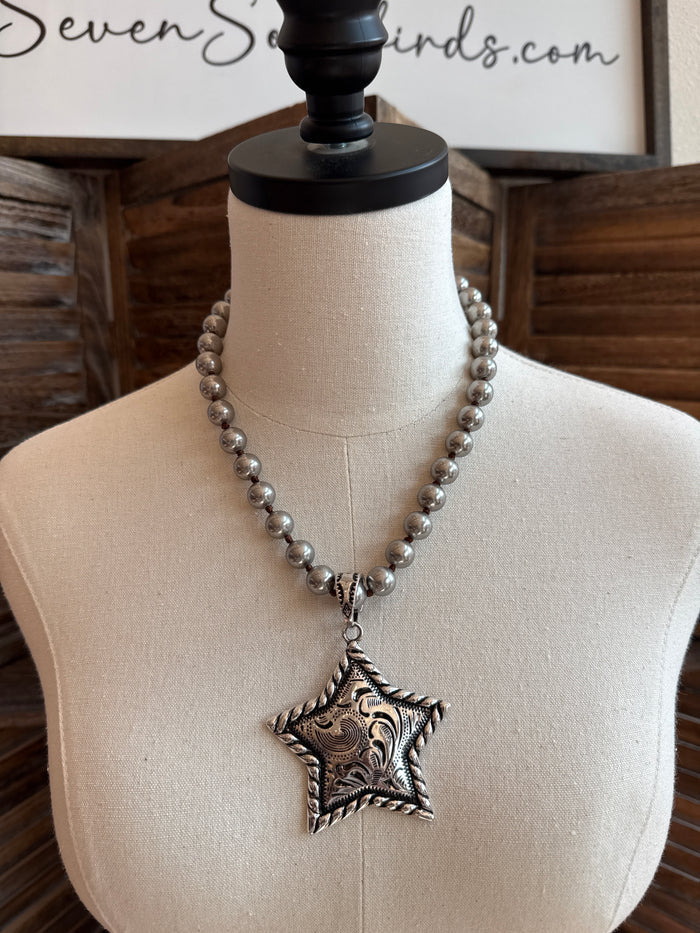 Silver beaded statement necklace with engraved star pendant on chain