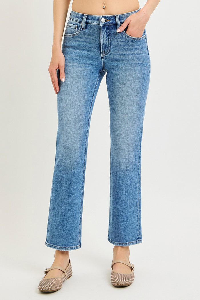 Women’s mid-rise ankle jeans in medium blue, front view with belt loops and button zip