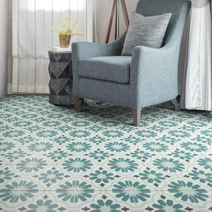Patterned tile floor with a gray armchair and decorative elements.