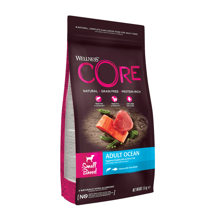 White background with a picture of a bag of Wellness CORE Ocean Small Dog Food. On the bag is pictures of Salmon fillet, tuna fillet and peas. The text on the bag 'Wellness CORE, Natural, Grain Free, Protein-Rich' and 'Small breed, Adult Ocean, Salmon with Tuna Recipe'.