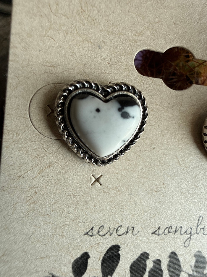 Heart stud earring with white heart center and silver-tone ornate heart frame
