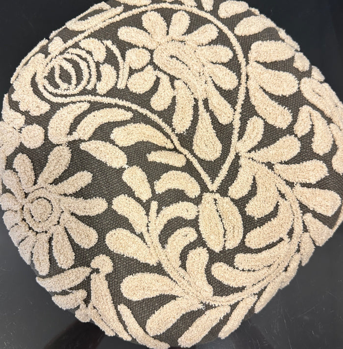 Decorative round pillow with floral pattern on a black background
