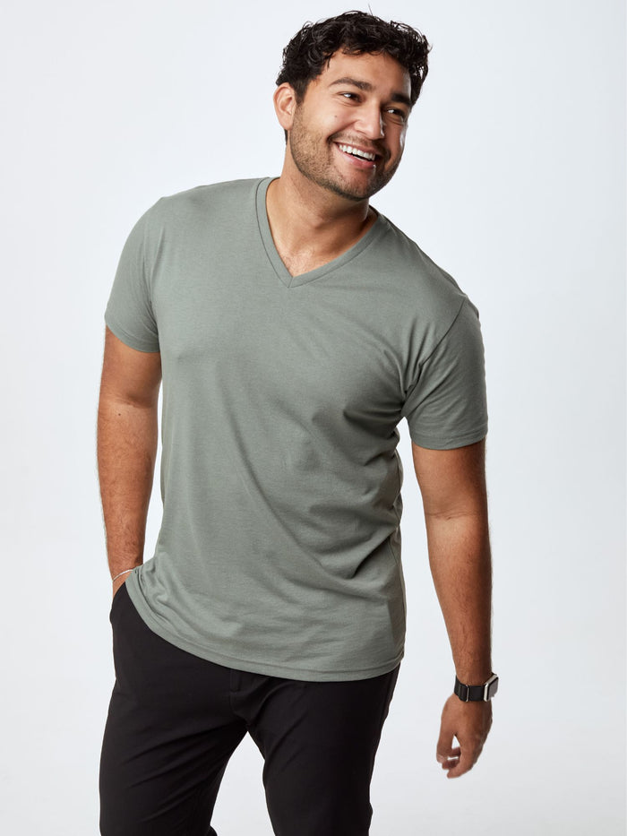 Matheus is 6', 210LBS and wears a size XL # Plain Mercury Green v-neck shirt, available in the Fall Essentials 5-Pack | Fresh Clean Threads