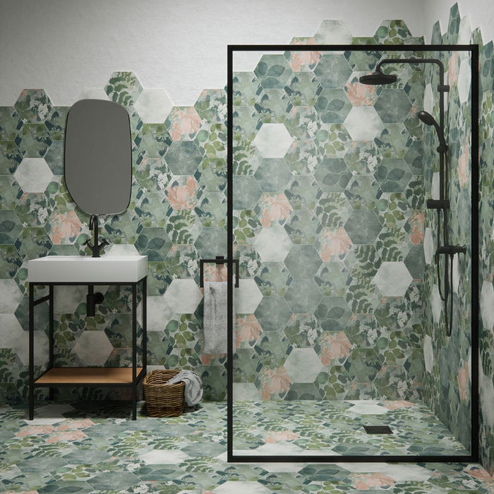 Bathroom with floral hexagonal tiles, a sink, and shower area.