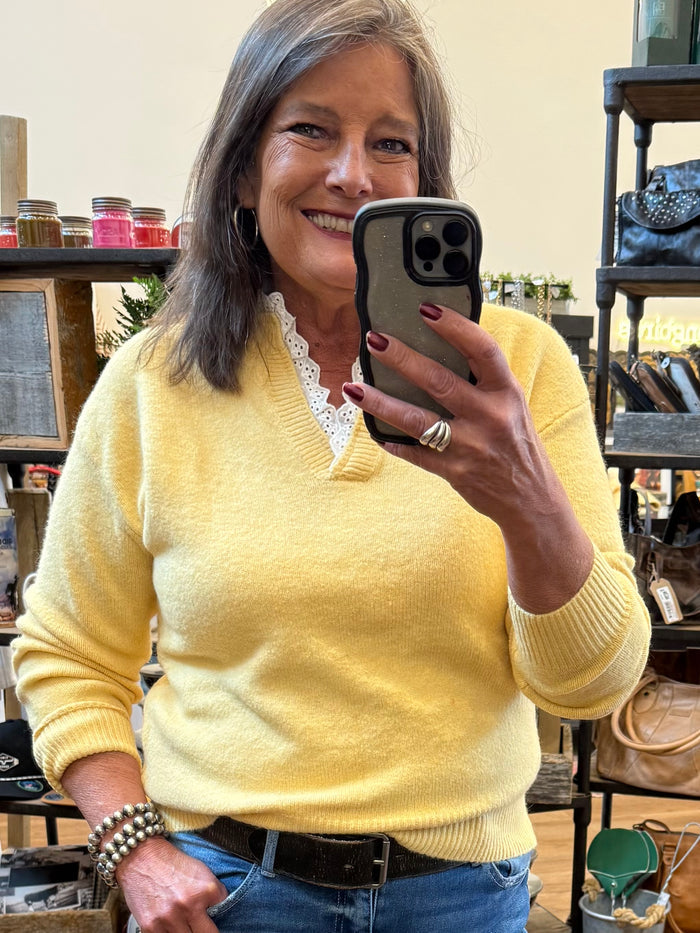 Yellow knit V-neck sweater with white lace collar and long sleeves